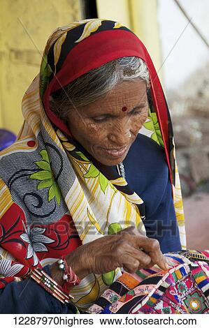Woman sewing sari; Dharpatha Mal, Madhya Pradesh, India View Large Photo Image Stock Photograph - Woman sewing sari; Dharpatha Mal, Madhya Pradesh, India. Fotosearch