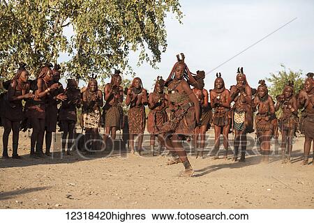 Women from Himba people in traditional clothes and haircuts are standing in a circle and dancing their original tribal dance; Namibia View Large Photo Image Stock Photograph - Women from Himba people in traditional clothes and haircuts are standing in a circle and dancing their original tribal dance; Namibia. Fotosearch