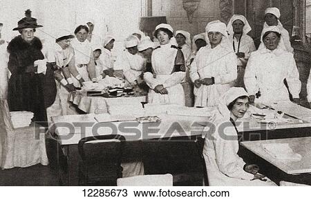Stock Image - Women volunteers making bandages and crutches during World War One. From The Pageant of the Century, published 1934. Fotosearch
