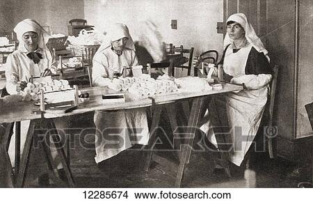 Picture - Women volunteers making hospital requisites for the St. John Ambulance Brigade Hospital during World War One. From The Pageant of the Century, published 1934. Fotosearch