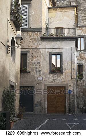 Wooden double doors on a residential building; Orvieto, Umbria, Italy View Large Photo Image Stock Photograph - Wooden double doors on a residential building; Orvieto, Umbria, Italy. Fotosearch