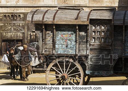 Stock Photograph - Wooden wagon in the street and a man leading a horse; Montepulciano, Toscana, Italy. Fotosearch