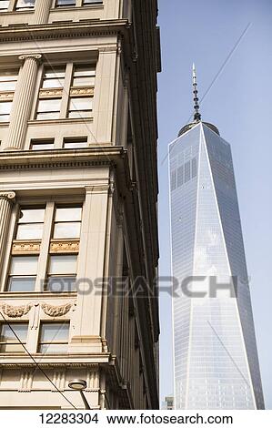 World Trade Centre tower behind older building; New York City, New York, United States of America View Large Photo Image Picture - World Trade Centre tower behind older building; New York City, New York, United States of America. Fotosearch