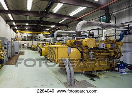 Stock Image - Yellow diesel generators at an electrical power plant, Sand Point, Southwestern Alaska, USA. Fotosearch