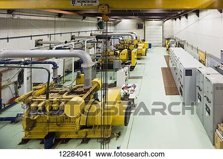 Stock Image - Yellow diesel generators at an electrical power plant, Sand Point, Southwestern Alaska, USA. Fotosearch
