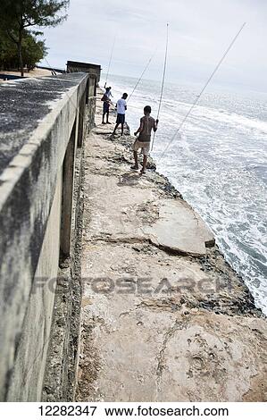 Stock Photo - Young boys fishing in the Indian Ocean; Manakara, Madagascar. Fotosearch