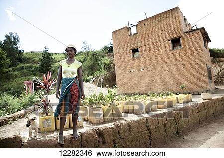 Young woman in front of her house and container gardening; Madagascar View Large Photo Image Stock Photograph - Young woman in front of her house and container gardening; Madagascar. Fotosearch