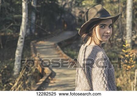 Young woman wearing hat standing on wooden walkway near Creamer's Field, Fairbanks, Interior Alaska, Autumn View Large Photo Image Stock Photography - Young woman wearing hat standing on wooden walkway near Creamer's Field, Fairbanks, Interior Alaska, Autumn. Fotosearch