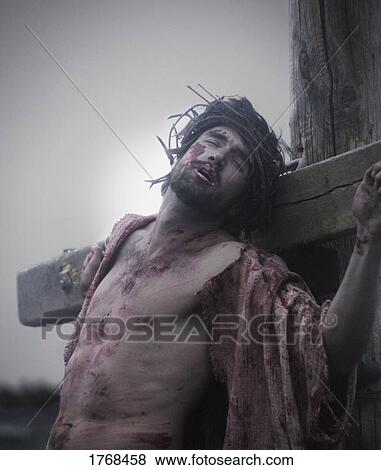 Christ hangs on the cross View Large Photo Image Stock Photo - Christ hangs on the cross. Fotosearch