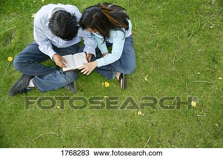 Couple reading together View Large Photo Image Stock Image - Couple reading together. Fotosearch