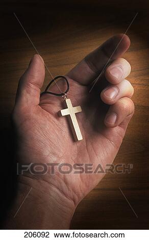 Cross pendant in open hand View Large Photo Image Stock Image - Cross pendant in open hand. Fotosearch