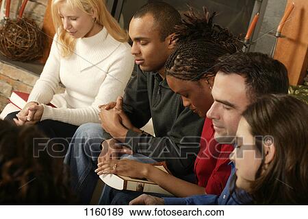 Group prayer at a Bible study View Large Photo Image Stock Photo - Group prayer at a Bible study. Fotosearch