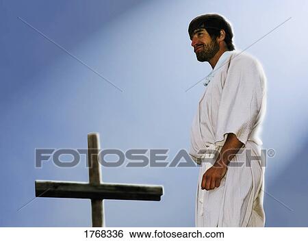 Jesus stands over the power of the cross View Large Photo Image Stock Photograph - Jesus stands over the power of the cross. Fotosearch