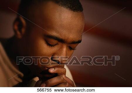 Stock Photography - Man in prayer. Fotosearch