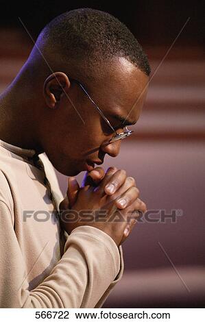 Stock Image - Man praying earnestly. Fotosearch