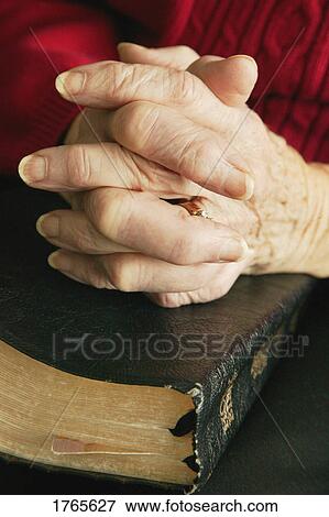 Senior praying with Bible View Large Photo Image Stock Photo - Senior praying with Bible. Fotosearch