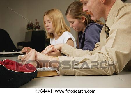 Stock Image - Small group prayer. Fotosearch