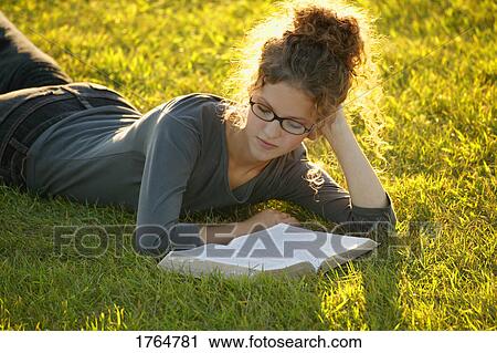 Stock Image - Teenager reads her Bible. Fotosearch