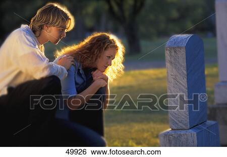 Stock Photograph - Visiting a grave. Fotosearch