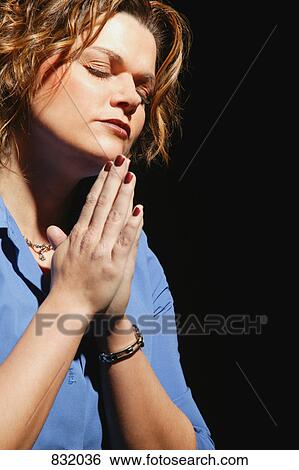 Woman in prayer View Large Photo Image Stock Photograph - Woman in prayer. Fotosearch