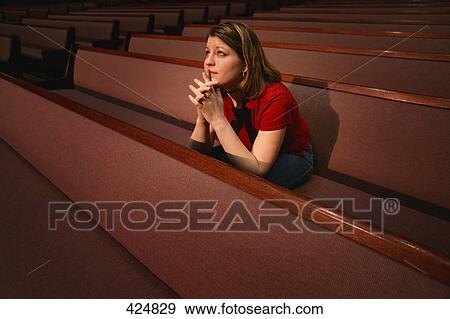 Woman praying in a church pew View Large Photo Image Stock Photo - Woman praying in a church pew. Fotosearch