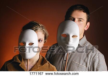 Stock Photo - Caucasian man and woman with white masks. Fotosearch