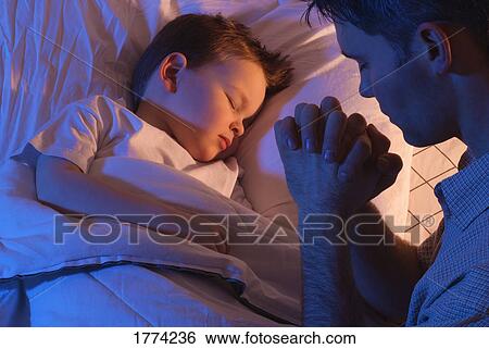Stock Photograph - Father praying for son. Fotosearch