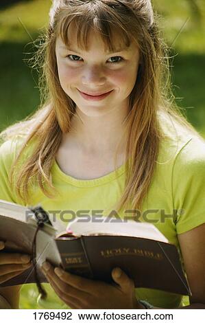 Girl reads a book View Large Photo Image Stock Image - Girl reads a book. Fotosearch
