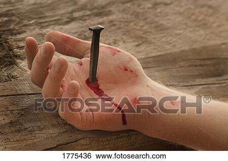 Stock Photograph - Nail in hand. Fotosearch