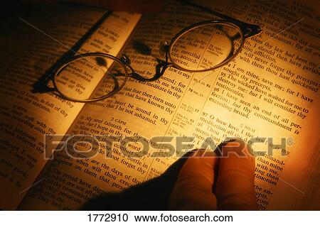 Open bible with glasses resting on it View Large Photo Image Stock Image - Open bible with glasses resting on it. Fotosearch