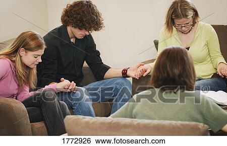 Stock Photograph - Prayer group. Fotosearch