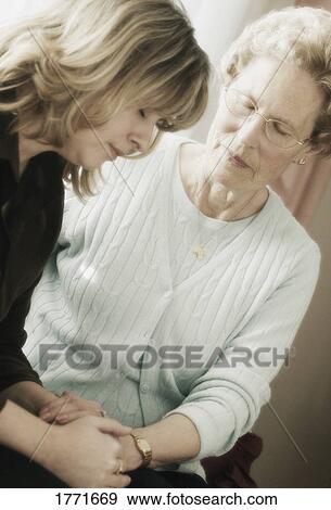 Senior and Woman praying View Large Photo Image Stock Photo - Senior and Woman praying. Fotosearch