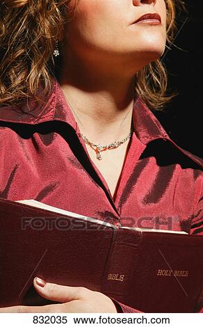 Woman holding Bible View Large Photo Image Stock Photography - Woman holding Bible. Fotosearch