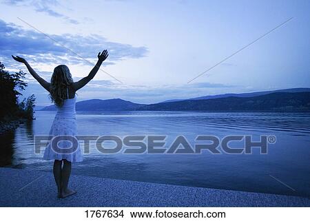 Woman lifts her hands towards heaven View Large Photo Image Picture - Woman lifts her hands towards heaven. Fotosearch