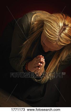 Stock Image - Woman praying. Fotosearch