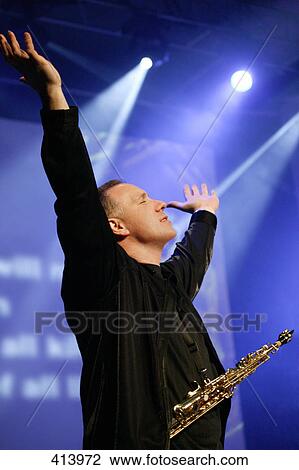 Stock Image - Worship leader raising hands. Fotosearch