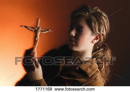 Young woman with symbol of Crucifixion View Large Photo Image Stock Photo - Young woman with symbol of Crucifixion. Fotosearch