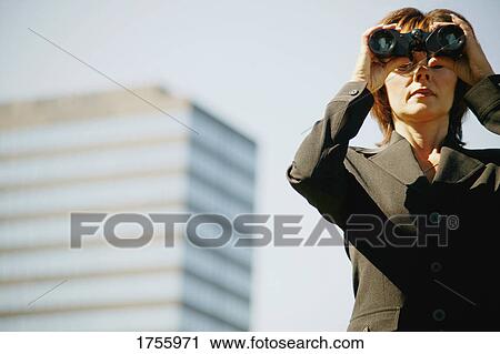 Stock Image - Businesswoman looks into the future. Fotosearch
