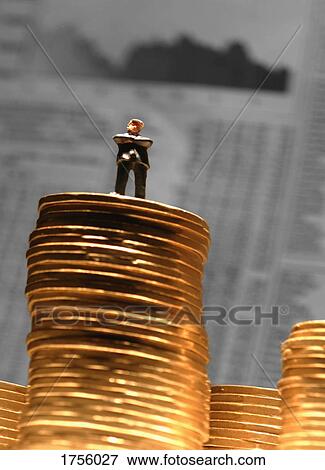 Man standing on a stack of money View Large Photo Image Stock Photo - Man standing on a stack of money. Fotosearch