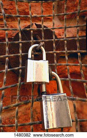 Padlocks on a weathered wire fence View Large Photo Image Stock Image - Padlocks on a weathered wire fence. Fotosearch