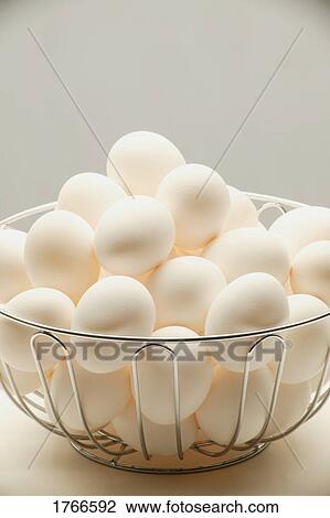 Stock Image - Closeup of a basket of eggs. Fotosearch