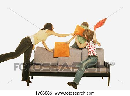 Stock Photography - Three women have a pillow fight. Fotosearch