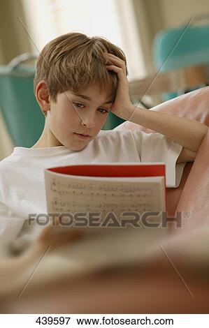 Boy reading a music book View Large Photo Image Stock Photo - Boy reading a music book. Fotosearch