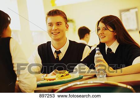 Stock Image - Classmates eating lunch. Fotosearch