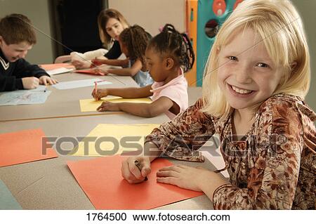 Stock Image - Girl colors a picture. Fotosearch