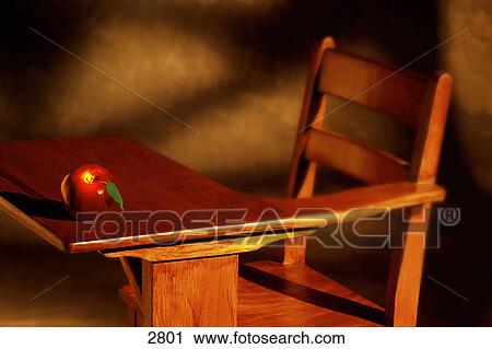 Stock Image - School desk and apple. Fotosearch