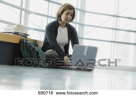 Stock Photograph - Student does homework in school. Fotosearch