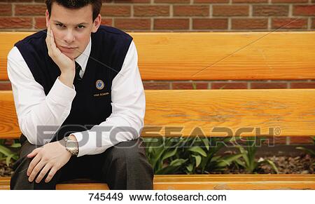 Stock Photo - Student sitting alone. Fotosearch
