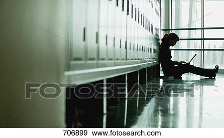 Student sitting by lockers View Large Photo Image Stock Photo - Student sitting by lockers. Fotosearch