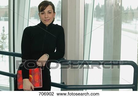Stock Image - Student standing in hallway. Fotosearch